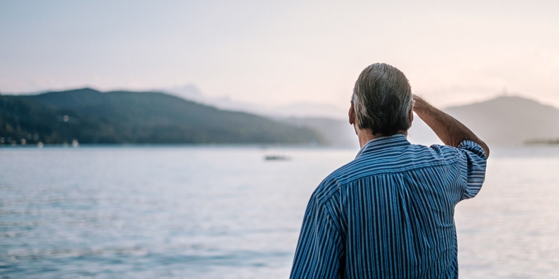 senior looking out across a lake