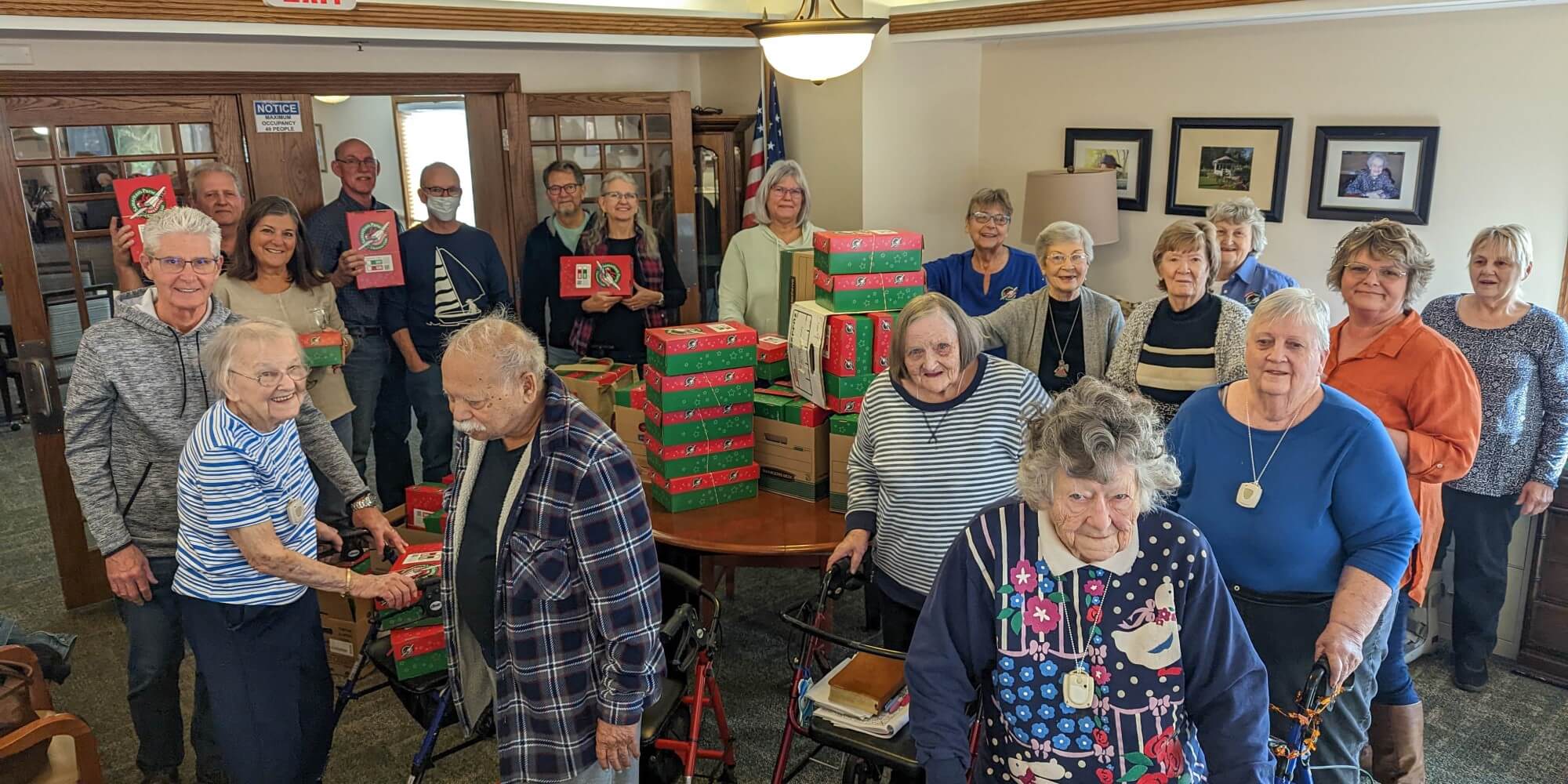 Operation Christmas Child Christian Haven residents showing off all the boxes they packed for Operation Christmas Child