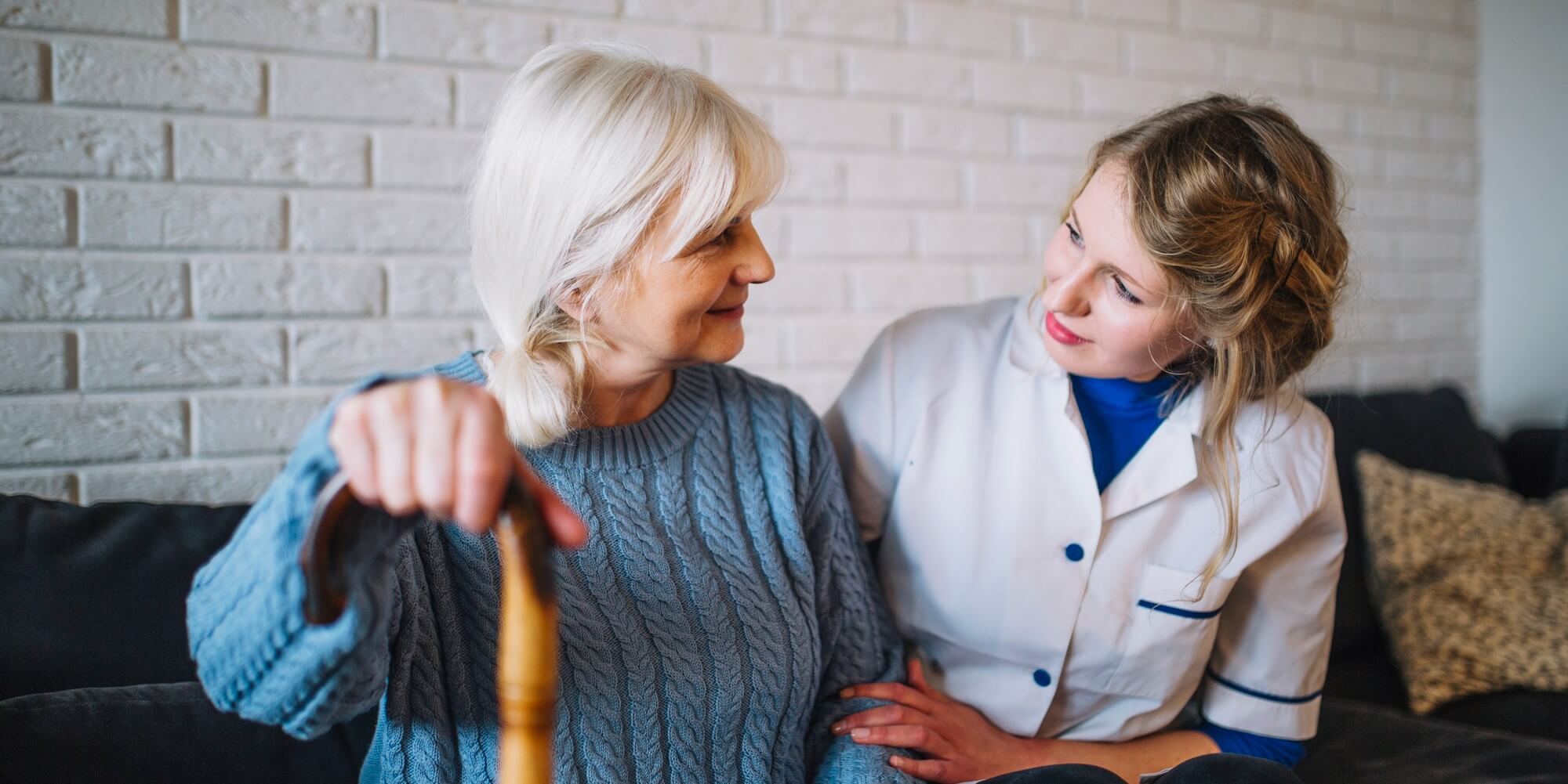 senior with a caregiver caregiver checking on a senior