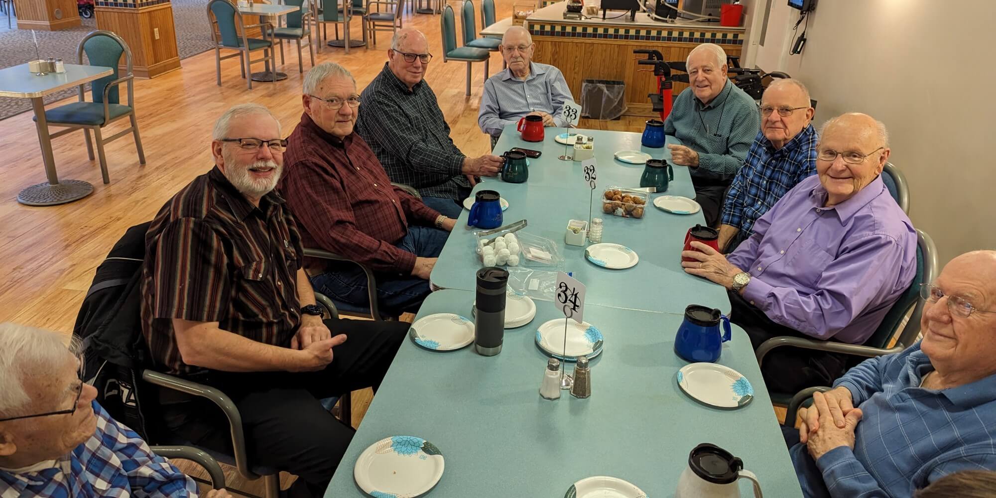 Men’s Coffee group of elderly men sitting around a table