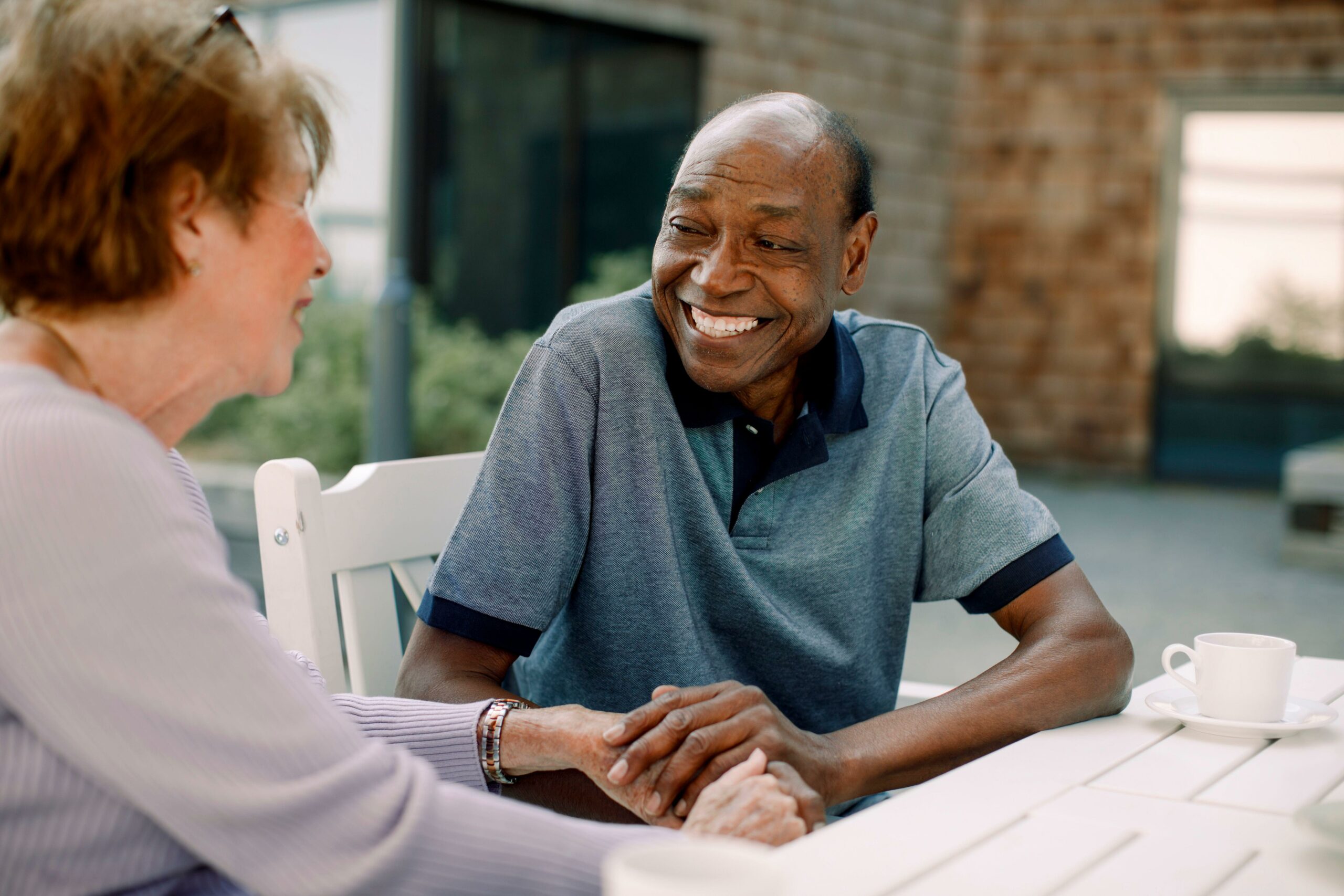Elderly Man Outside Chatting with Woman-min