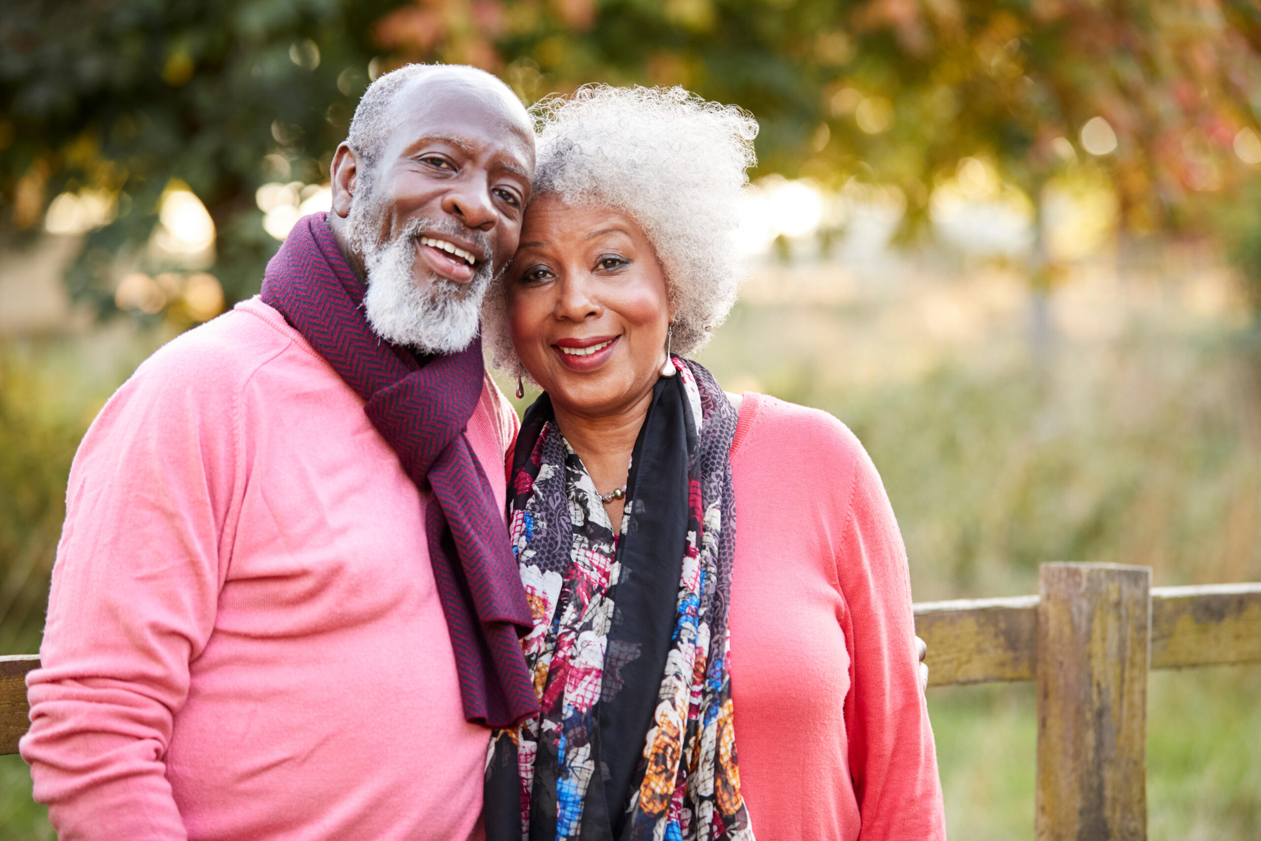 Portrait Of Senior Couple On Autumn Walk In Countryside Together Elderly man outside chatting with a woman