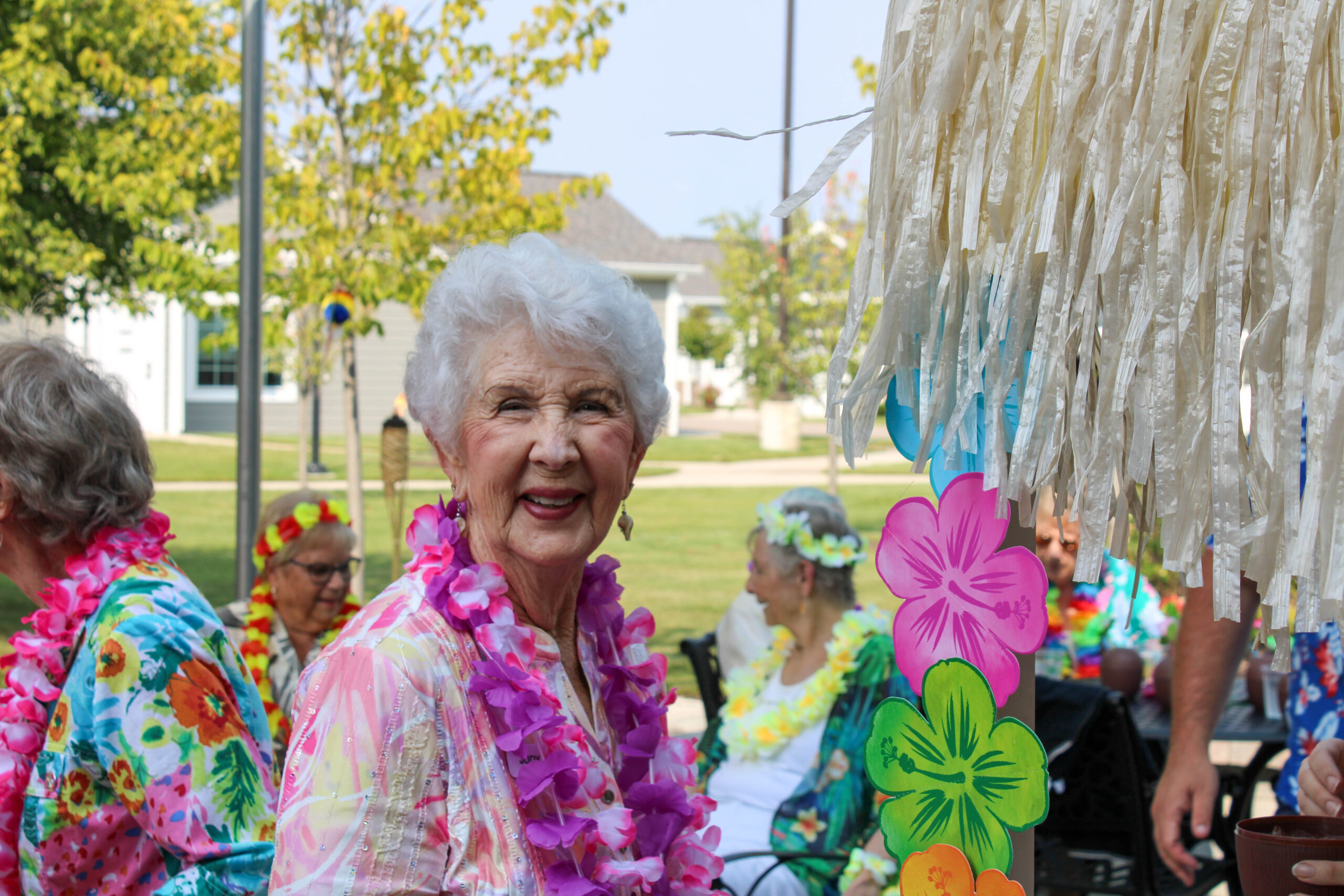 WP Luau – 32 Woman at Luau event at senior living community.